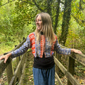 Woman wearing the Saffron Sky Gudri Jacket in red, cobalt blue and cream reclaimed cotton with kantha stitching