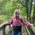 Woman wearing pink reclaimed cotton Gudri jacket with traditional kantha stitching, back view