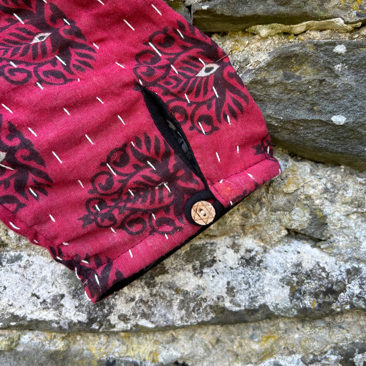 Red and black Gudri jacket coconut button cuff detail
