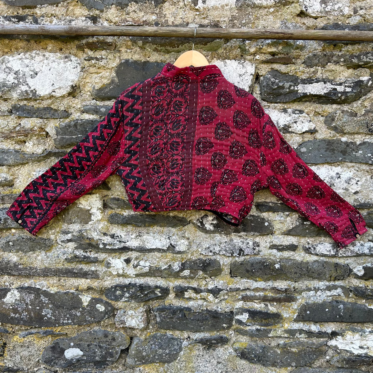 Red and black women’s Gudri jacket made from reclaimed cotton with kantha stitching, back view