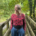 Woman wearing the red and black Crimson Trail Gudri jacket with kantha stitching and cropped zip-front design