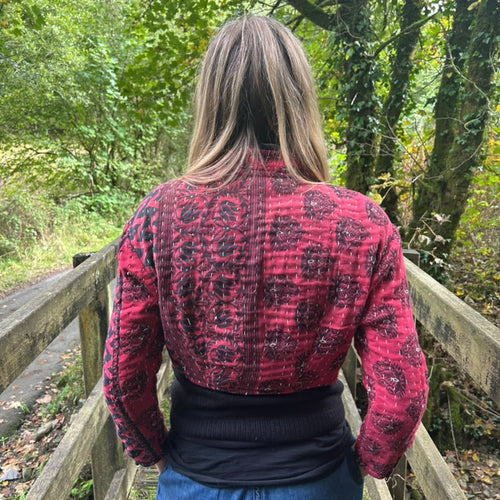 Back view of red and black Crimson Trail Gudri jacket with traditional kantha running stitch
