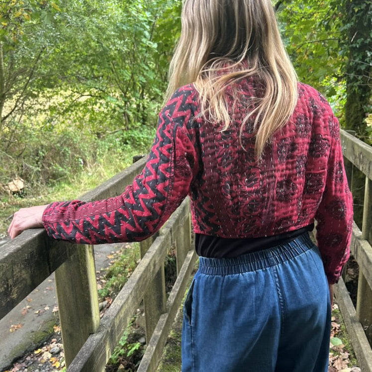 Back and sleeve detail of red and black Crimson Trail Gudri jacket with traditional kantha running stitch