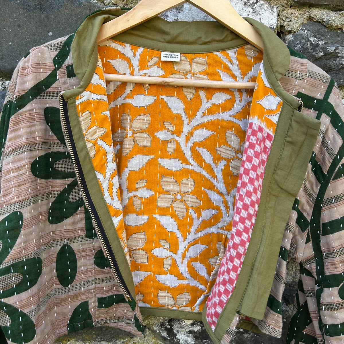 Forest Bloom Gudri jacket open to show contrasting orange reclaimed cotton lining and kantha stitching
