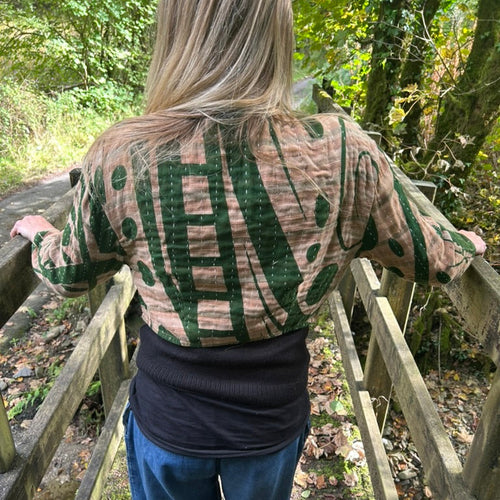 Back view of Forest Bloom green and stone reclaimed cotton Gudri jacket showing kantha stitching and patterned textile