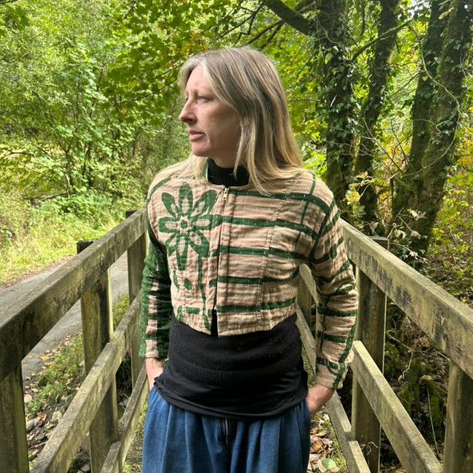 Woman wearing the Forest Bloom green and stone reclaimed cotton Gudri jacket with kantha stitching